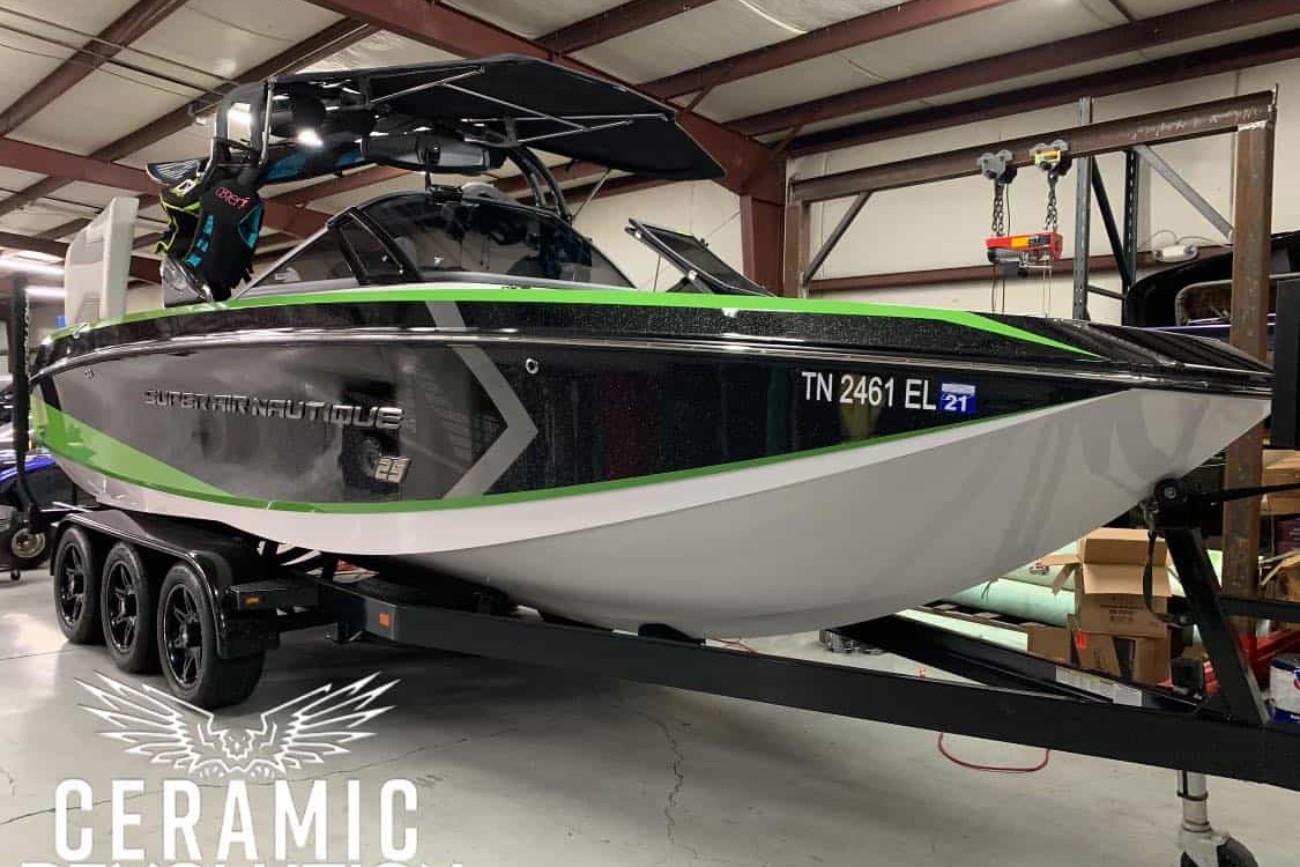 black and green boat on a trailer